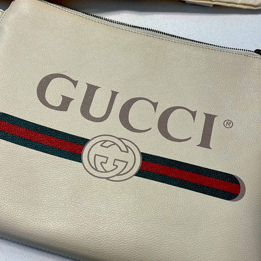 Gucci cream colored pebbled calfskin large clutch. Like new on outside.